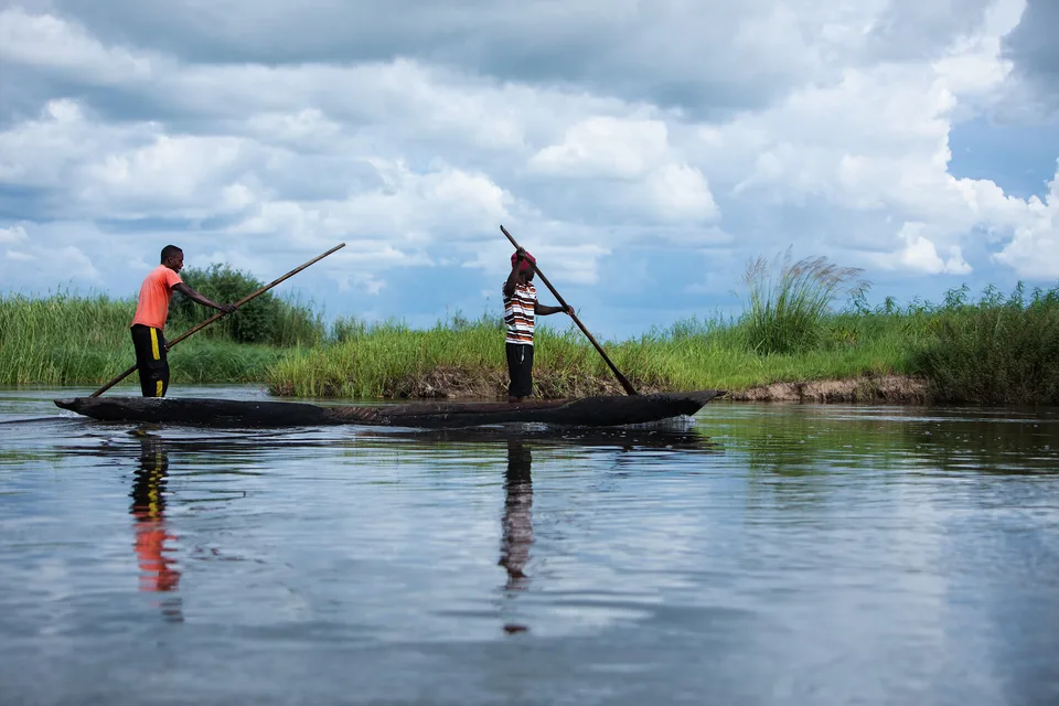 Two fishermen in a dugout canoe on the Barotse floodplain, Western Province, Zambia